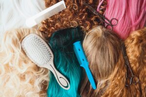 Hairdresser tools over a many color and natural wigs